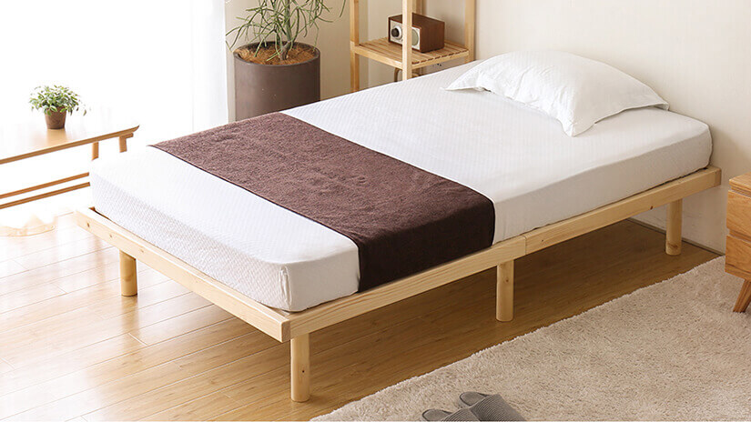 Cuenca pine bed frame in a Scandinavian-style bedroom