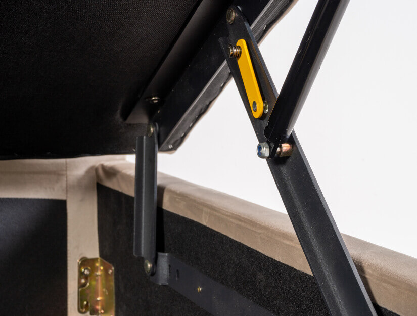 German-designed hydraulic lift with the yellow safety lock holding the storage base open